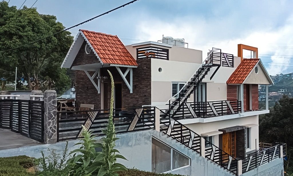 Two-story hillside residence with terracotta tile gables built by New Heights Builders