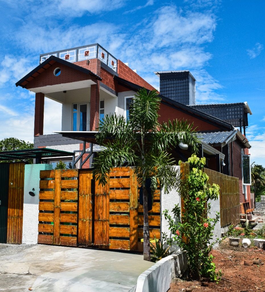 Bespoke villa with handcrafted timber gate and courtyard garden built by New Heights Builders