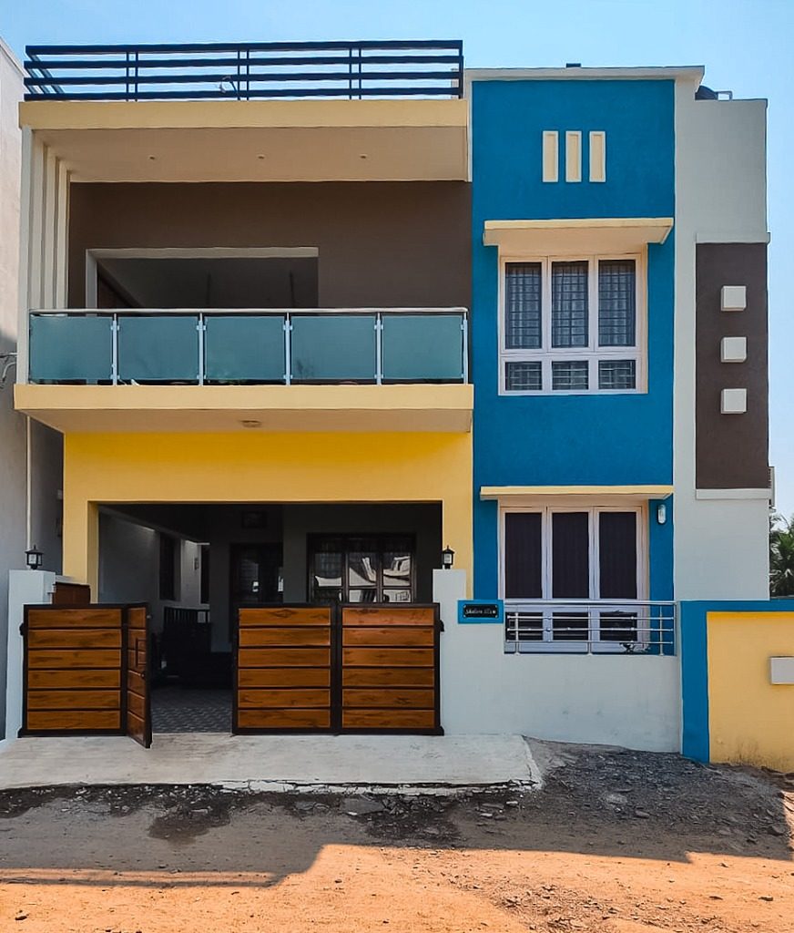 Contemporary two-story house with azure blue and yellow elevation accents built by New Heights Builders